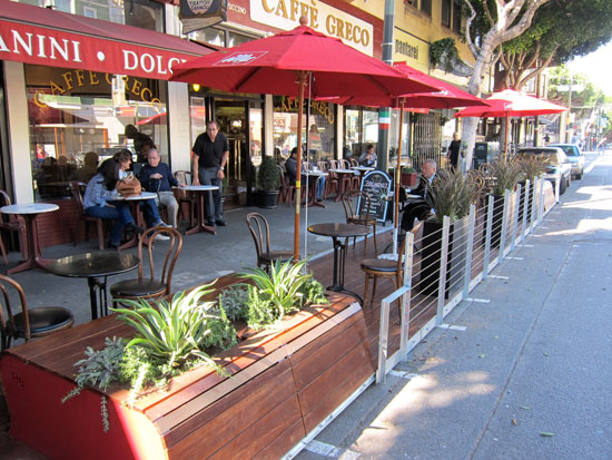 Two parking spaces are now cafe seating, benches and plants. Photos: Matthew Roth