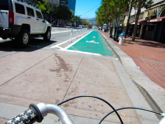 Bicycle advocates don't want to wait six months for more green protected bike lanes on Market Street. Photo: Myleen Hollero/Orange Photography