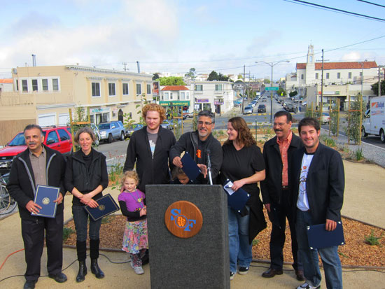 Supervisor John Avalos, at the lectern, hands out commendations to the people who designed the park and mural.