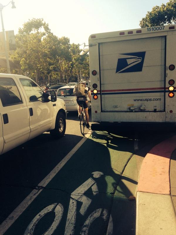 Despite the green paint added last year, the existing Embarcadero bike lanes are routinely blocked by private auto and delivery drivers. Photo: SFBC/Twitter