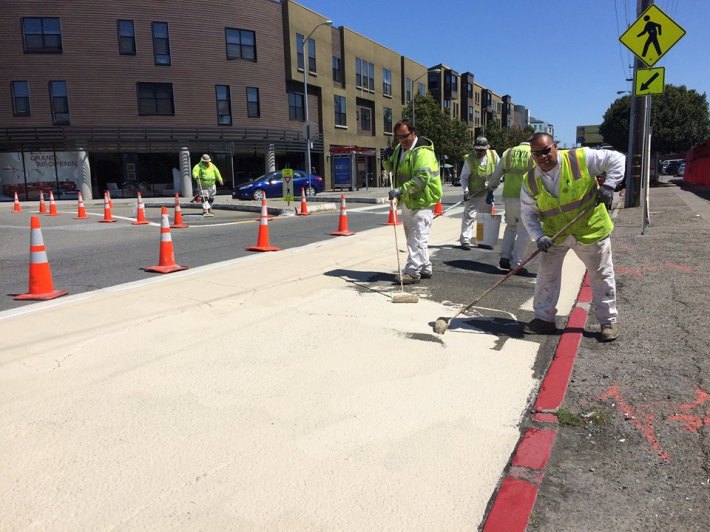 SFMTA crews install painted curb extensions today at the traffic circle at Eighth and Division Streets. Photo: SFMTA Livable Streets/Facebook