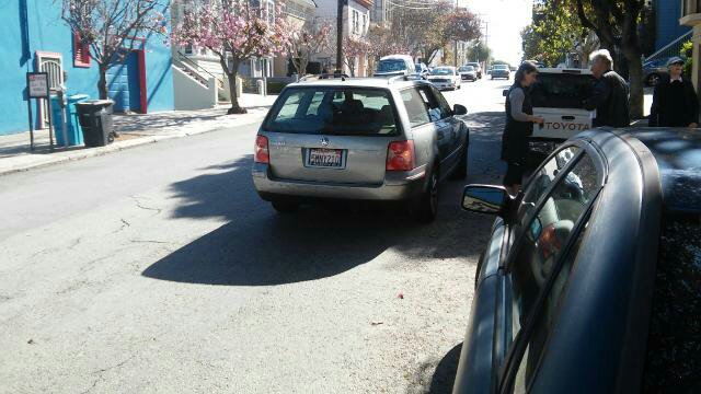 On Tuesday, a driver (the woman left of the man) hit a woman (seen wearing a hat) while turning right at the same crosswalk. Photo: Hank Cancel