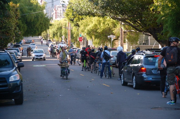 At yesterday's "stop-in" on the Wiggle, bike commuters queued up for over a block to make a full stop at Steiner and Waller Streets. Photo: Aaron Bialick