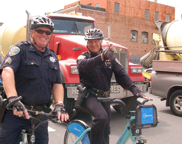 A photo from August 2013. SFPD Chief Greg Suhr, right, gives a thumbs up at a stop light on Seventh Street on yesterday's bike-share celebration ride to City Hall. Photo: Aaron Bialick