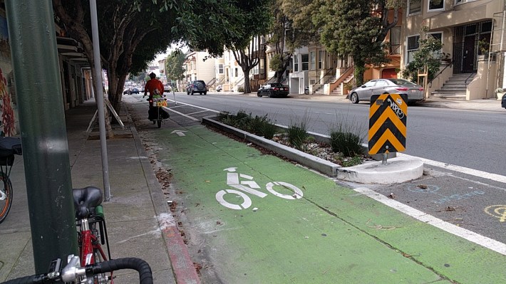 A rare bike lane without a car in it. Could it have something to do with the concrete divider? Photo: Streetsblog.