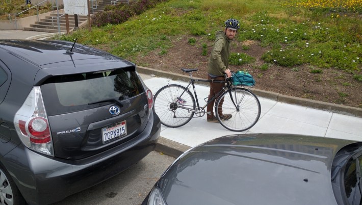 One year ago, Ryan dove between two parked cars at this very spot to avoid a raging motorist who tried to back over him. Photo: Streetsblog.