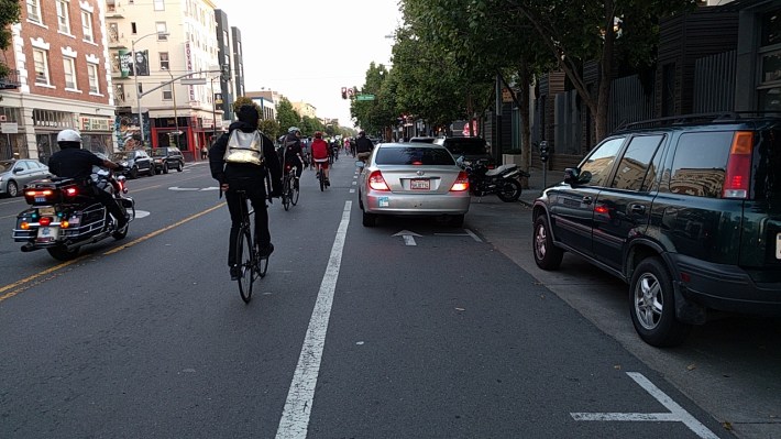 As is nearly always the case, cyclists had to navigate around this car illegally stopped in the bike lane. Photo: Streetsblog