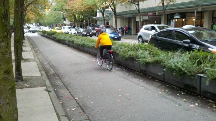 In Vancouver, rather than pain in temporary measures, the put down planters to protect cyclists. Photo: Streetsblog.