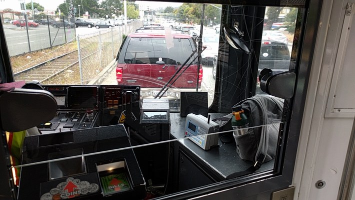 View from inside an inbound M-Oceanview. If SF's 'Transit First' policy is behind the push to regulate Chariot, then why does SFMTA allow trains full of people to sit in a mixed-flow turning pocket waiting for cars to make a left into a mall? Photo: Streetsblog.