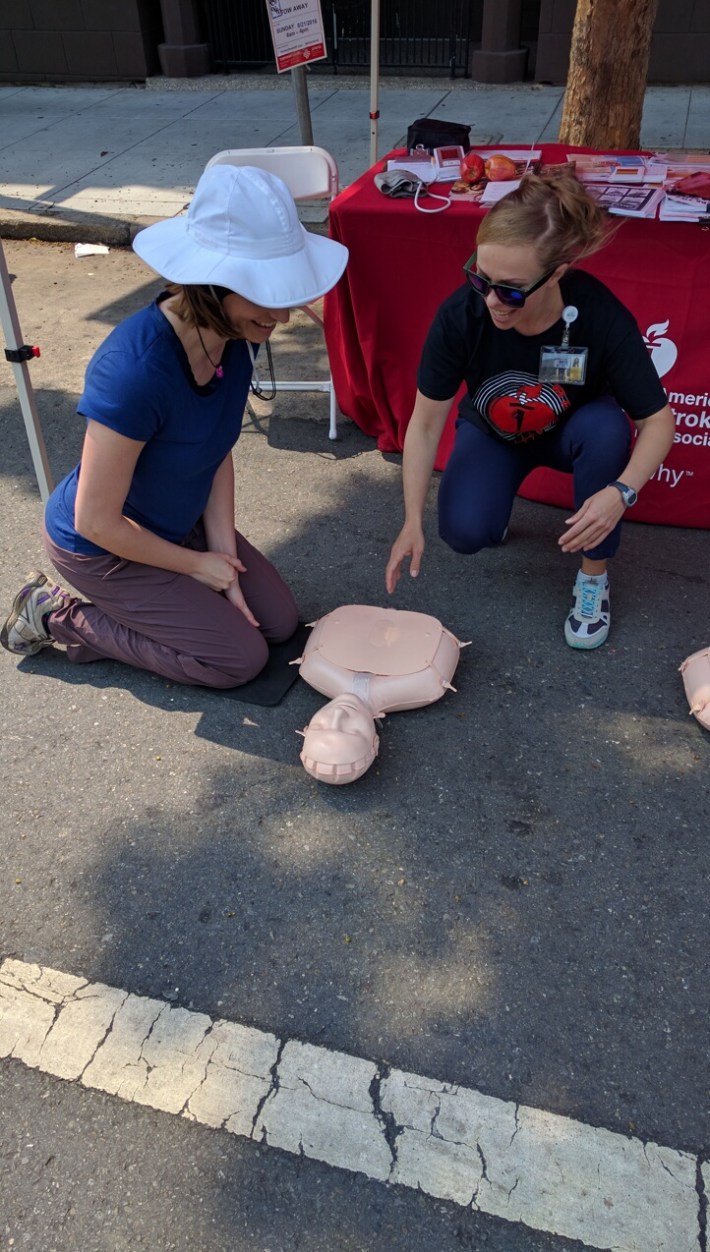 Olga Fedyukova, also a nursing student at USF, teaches a passerby the basics of CPR. Photo: Streetsblog.