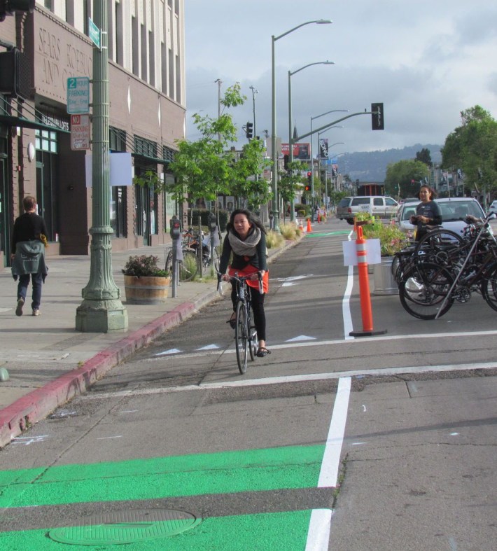Oakland will be getting more parking-protected bike lanes like this one demonstrated by Bike East Bay. But will the potholls get repaired? Photos: Melanie Curry