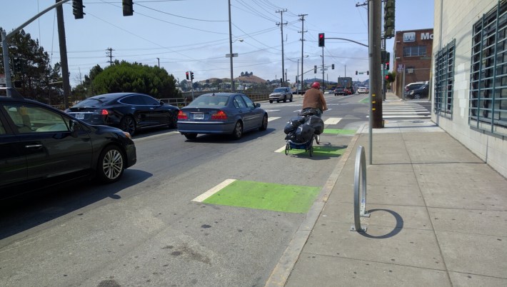 A homeless man towing a makeshift bike trailer on Cesar Chavez, most likely back to a hairball encampment. Photo: Streetsblog.