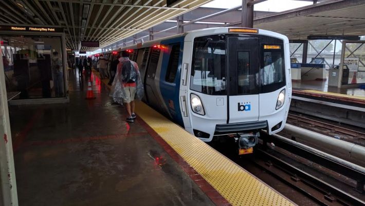 Rain didn't stop hundreds of BART customers from coming to MacArthur Station to see the new train car. Photo: Streetsblog