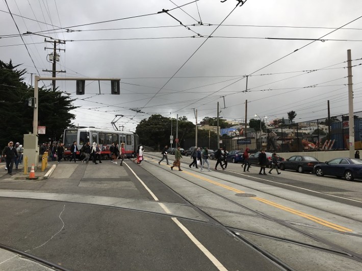 Muni track junctions, pedestrian crossings, bus stops, car lanes, highway ramps and no real bike infra make a dangerous combination. Photo: SFMTA.