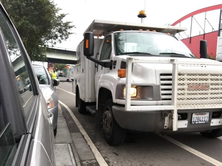 Streetsblog readers have probably seen this shot of an SFMTA truck blocking the bike lane on Folsom while it removes SFMTrA's unofficial posts. Photo: SFMTrA