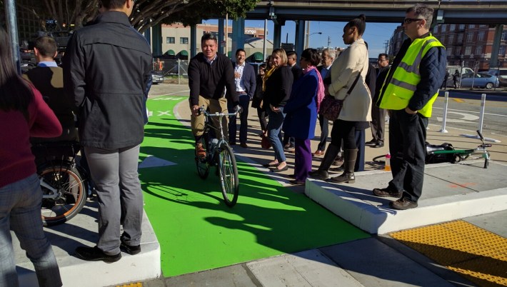 A regular cyclist rolling comfortably through, probably wondering what the press conference was all about. Photo: Streetsblog