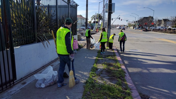 Volunteers cleaning the sidewalk on Fruitvale Ave. Photo: Streetsblog