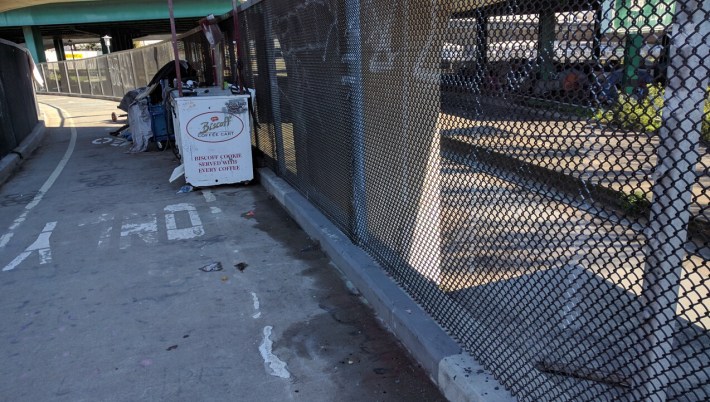 In addition to the tents and garbage, there's what looks like a commercial freezer on the path. Photo: Streetsblog/Rudick