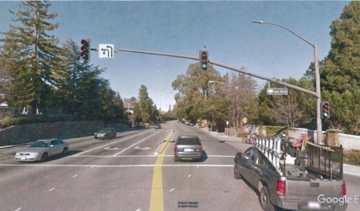 Including turn lanes, Santa Cruz Avenue is seven lanes wide at Sand Hill Road. High traffic speeds and volumes discourage walking and bicycling here. Photo: Google Earth