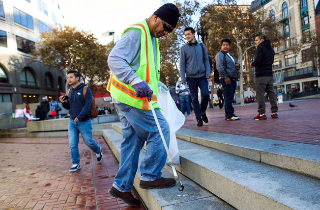 A member of a clean-up team helps keep the center tidy. Photo: :Office of Economic and Workforce Development