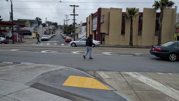 Streetsblog returned today and within minutes saw a pedestrian, with no other obvious way to cross, repeat the same pattern from the night before to get across the street. Photo: Streetsblog/Rudick