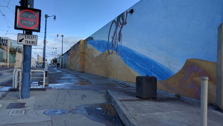 At the end of the mural, and at the very end of the bike route, waits the Pacific Ocean. And motorists, please don't drive into the subway tunnel. Photo: Streetsblog/Rudick