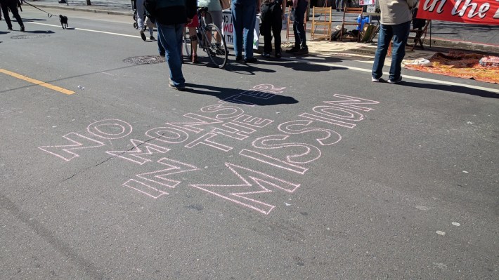 A group objecting to more housing in the Mission scrawled their message on Valencia. Photo: Streetsblog/Rudick
