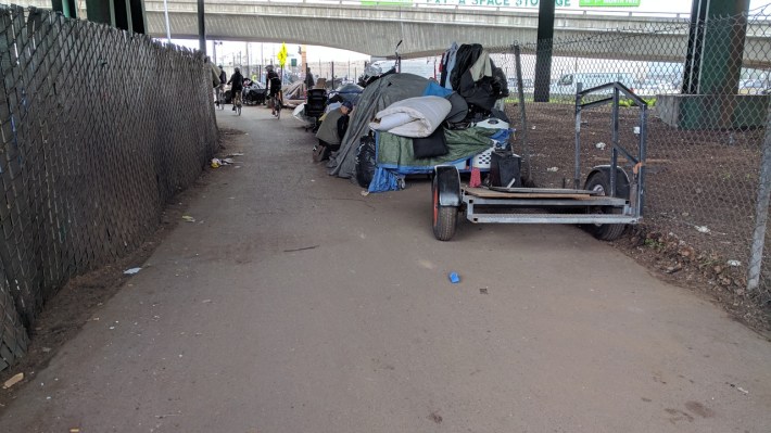 Homeless tents and debris blocking the bike path. Photo: Streetsblog/Rudick