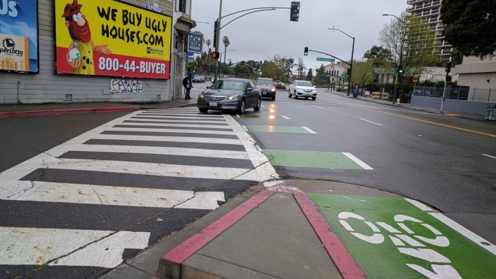 Mixing a bike lane with the high-speed turnout at Grand and International makes cycling here very uncomfortable. Photo: Streetsblog/Rudick