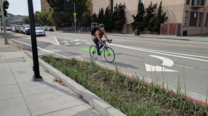 Thanks to lack of budget and coordination, cyclists are forced to mix with right-turning cars at the northern end of the protected bike lane. Photo: Streetsblog