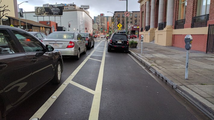 Some people still don't get it. Oakland DOT needs to borrow those signs from SFMTA on Valencia. Photo: Streetsblog/Rudick