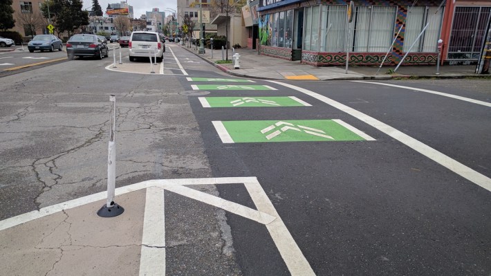 The addition of some safe-hit posts and kermit green helps make intersections on Telegraph a bit safer. Streetsblog/Rudick