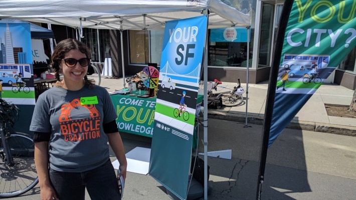 Hannah Cole, a volunteer with the Bike Coalition, with their new banners.