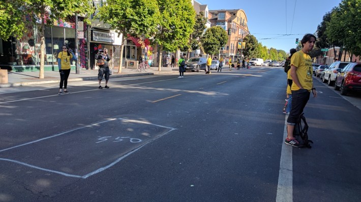 The bike lanes on both sides of Valencia, at least for one block, had human-protected bike lanes. Photo: Streetsblog/Rudick