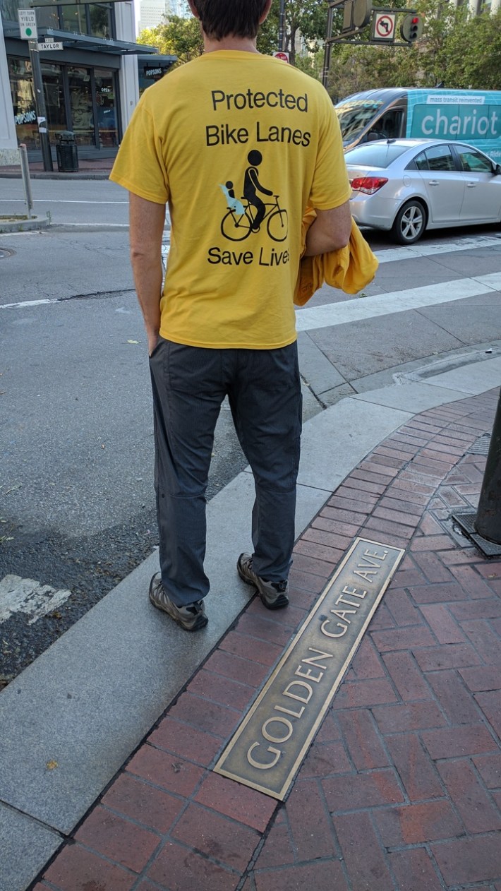 One of the lead organizers, back turned to conceal his identify, with yellow t-shirts.