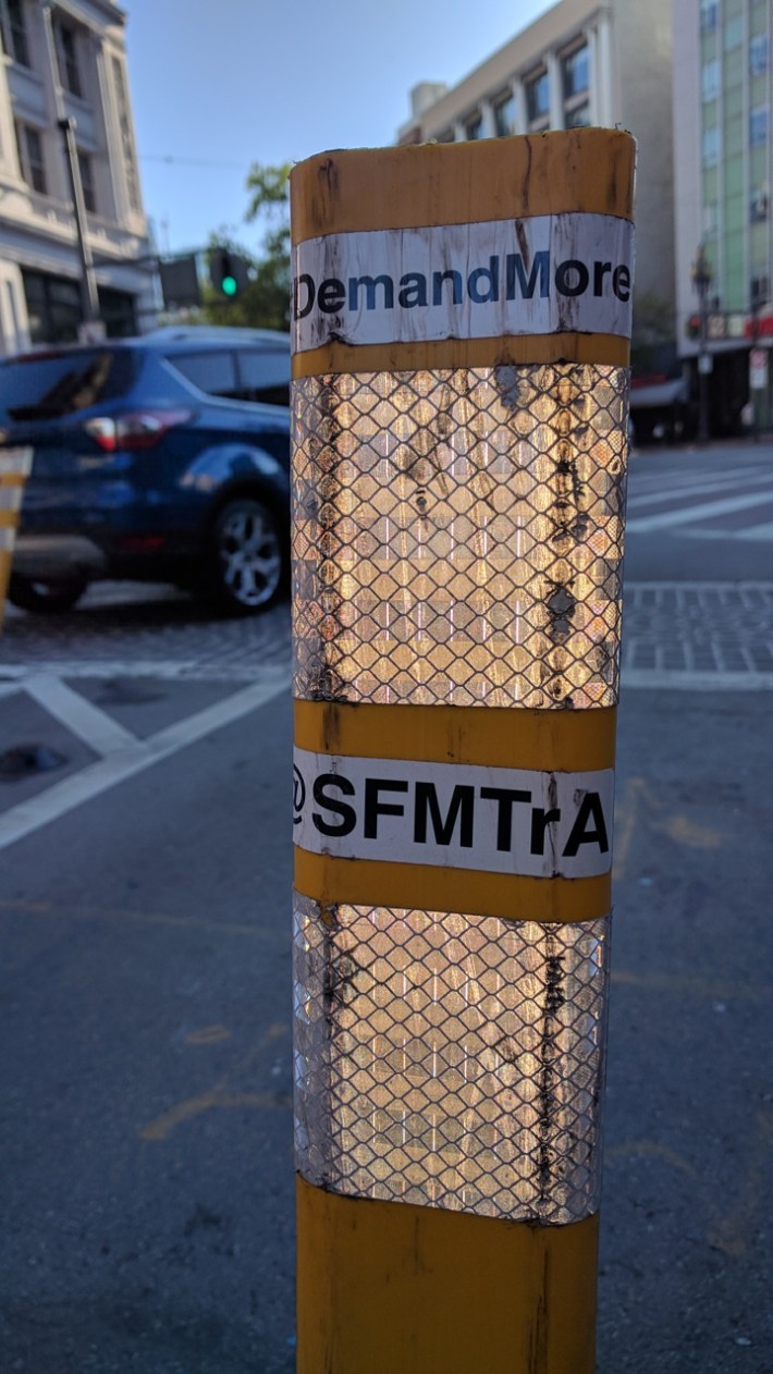 An unofficial safe-hit post, installed by SFMTrA, at the end of Golden Gate at Market.