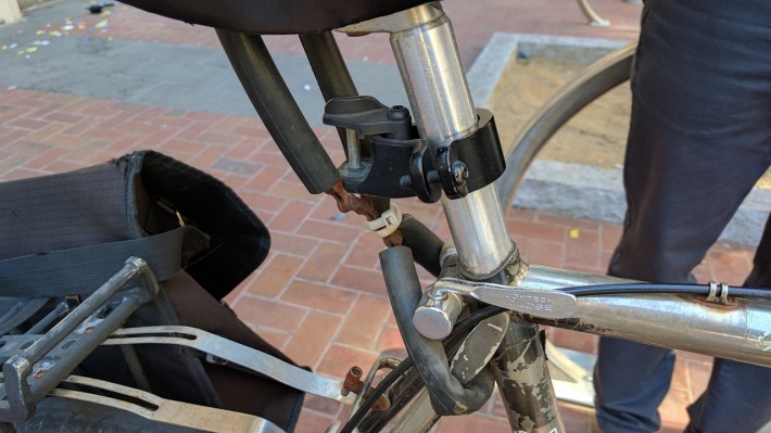 Some old bike chain and rubber tubing (to avoid catching your pants on it) keep this seat secure. Photo: Streetsblog/Rudick