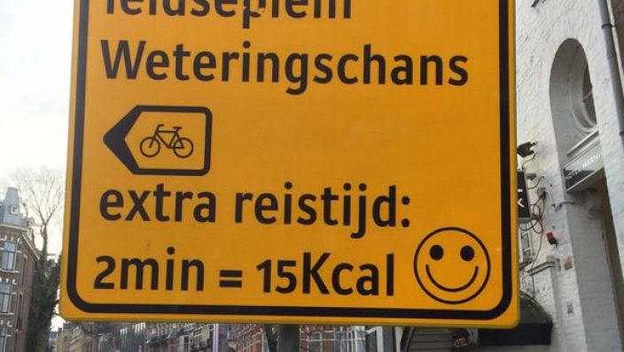A Dutch bicycle construction detour sign even tells you how many calories the detour will burn...15Kcal in this case. Photo: Mark Sloothaak