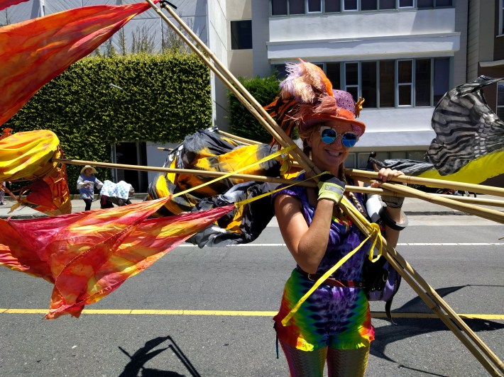 Toni Mikulka re-arranging her Kite Puppets at Sunday Streets in the Mission