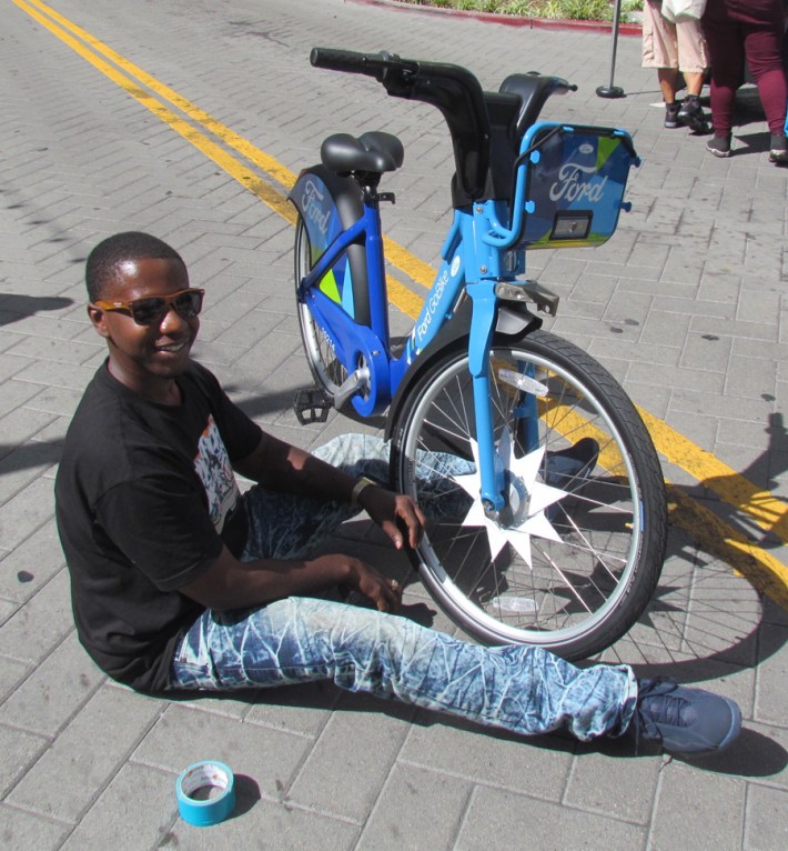 Champ of the Scraper Bike Team decorates a bike.