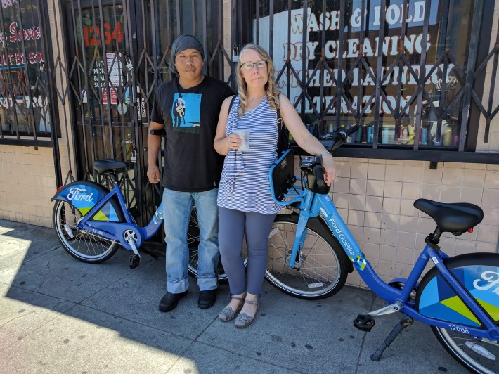 Christopher Serrano and Victoria Ruddick taking advantage of a promotion and a car-free Valencia to try out Ford GoBike