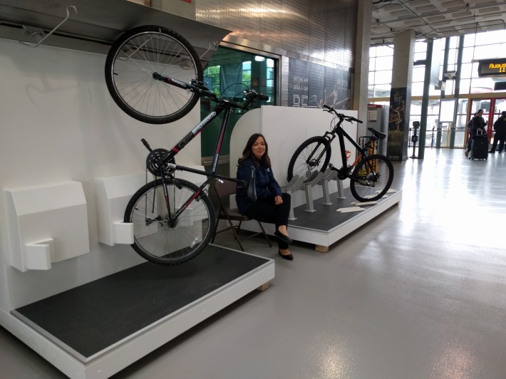 Amezcua sitting between the bike displays during a slow period at King Street Station.