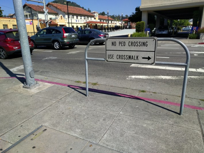 The cities have to make station areas more inviting than this. San Rafael is a nice downtown, but the area around the station is surrounded by beg-buttons and pedestrian diversions. Accessibility is very poor. Photo: Streetsblog/Rudick