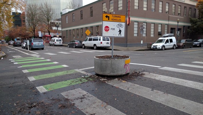 A heavy concrete planter is one way to make a crossing safer without waiting for new pavement. Seen here in Portland, Oregon. Photo: Streetsblog/Rudick