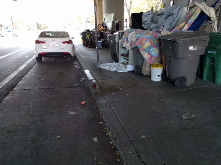 Transform's Clarrissa Cabansagan made the point that when existing sidewalks are completely blocked off by trash and encampments, talk of safety improvements to the sidewalk seem premature (and perhaps even absurd) to the community. Photo: Streetsblog/Rudick