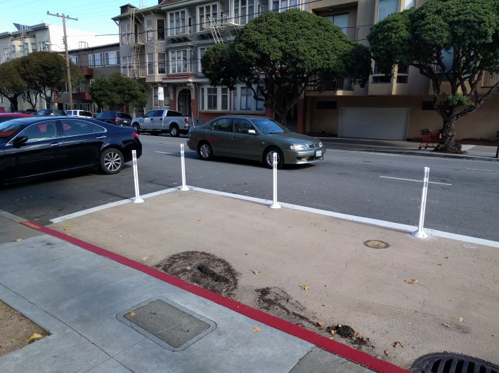 Safe hit posts and paint help force cars to make slower, more cautious turns from Baker onto Fell.