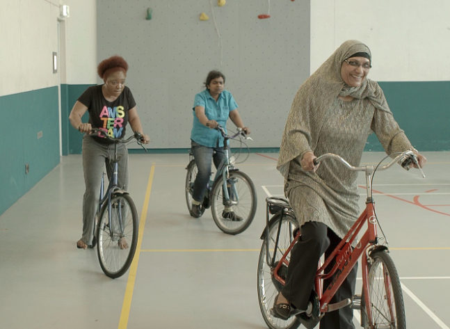 Migrant women learn to ride bikes in Amsterdam in the film 'Mama Agatha," from a publicity photo from the film.