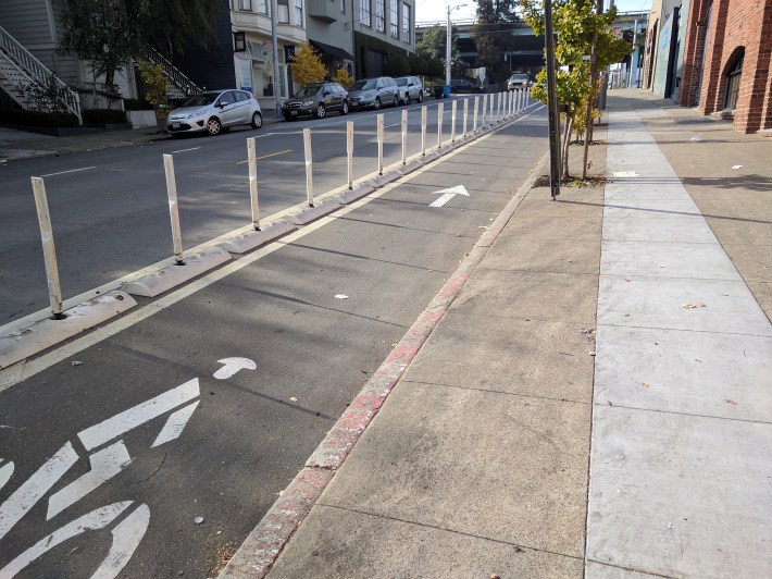 One of the short segments of plastic-bollard protected bike lane on one side of 17th. All protection abruptly disappears after four short blocks.