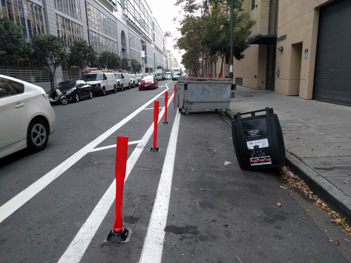 This was annoying on Friday morning, but at least cyclists don't have to worry about a dumpster suddenly pulling out or throwing open a door as they navigate around it. Photo: Streetsblog/Rudick