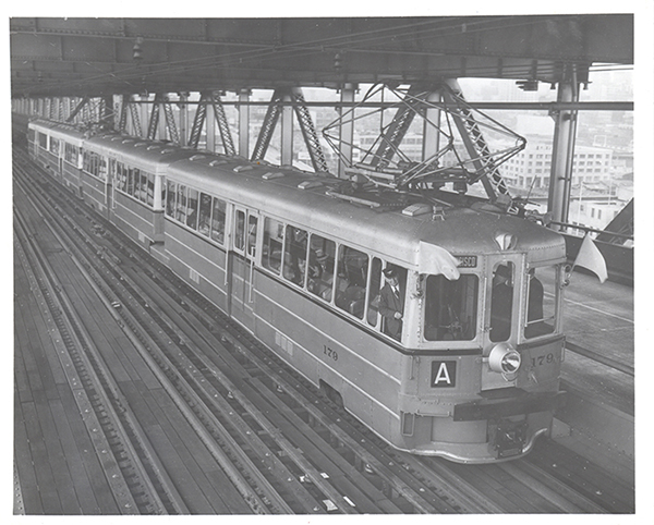 In the 1960s, the capacity of the Oakland Bay Bridge was reduced by removing these trains and tracks. Now AC Transit bus riders sit in traffic jams with everyone else. Photo: Transbay Joint Powers.